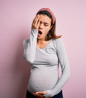 Pregnant woman yawning